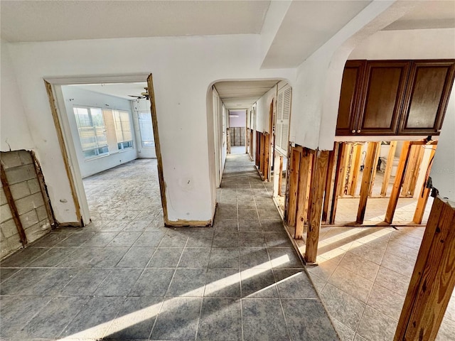 hall with dark tile patterned flooring