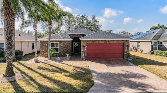 ranch-style home with a garage and a front yard