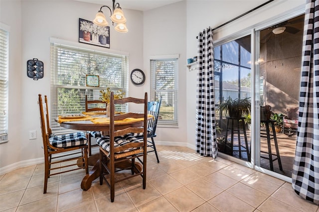 dining room with light tile patterned flooring and a notable chandelier