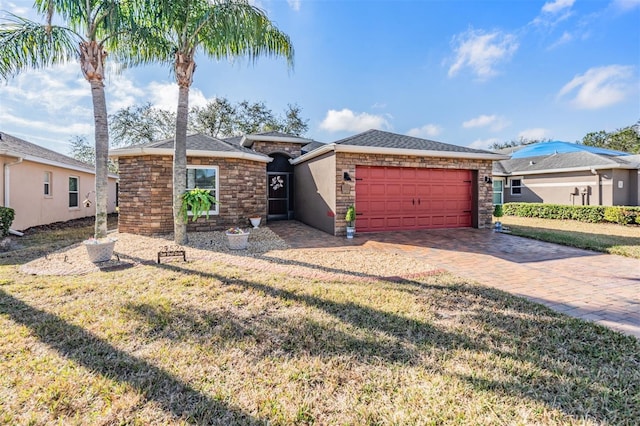 ranch-style home featuring a garage and a front lawn