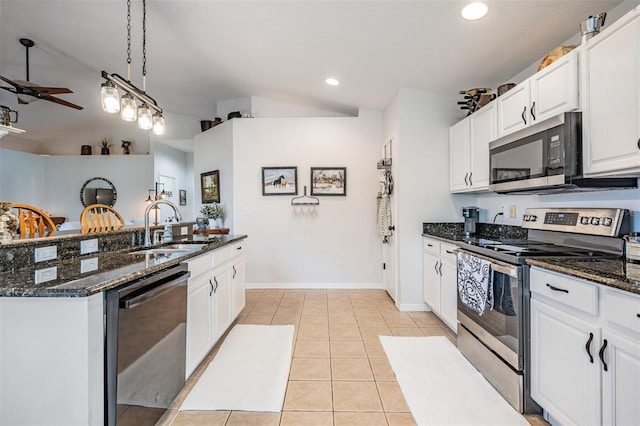 kitchen with pendant lighting, sink, light tile patterned floors, white cabinetry, and stainless steel appliances