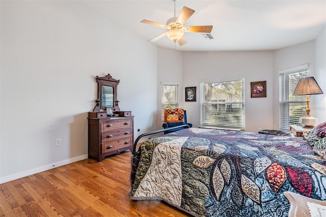 bedroom featuring lofted ceiling, ceiling fan, and light hardwood / wood-style flooring