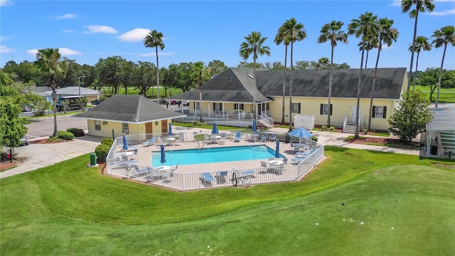 view of swimming pool featuring a yard and a patio area