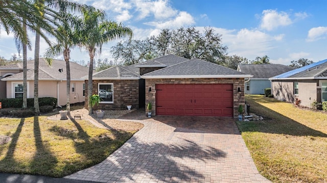 ranch-style house with a garage and a front lawn