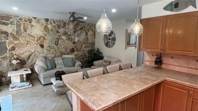 kitchen with light tile patterned floors and decorative light fixtures