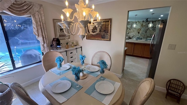 dining space with light tile patterned floors and a chandelier