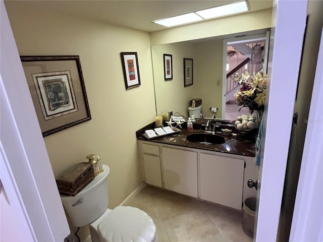 bathroom with vanity, toilet, and tile patterned flooring