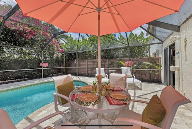 view of pool featuring a patio area and glass enclosure