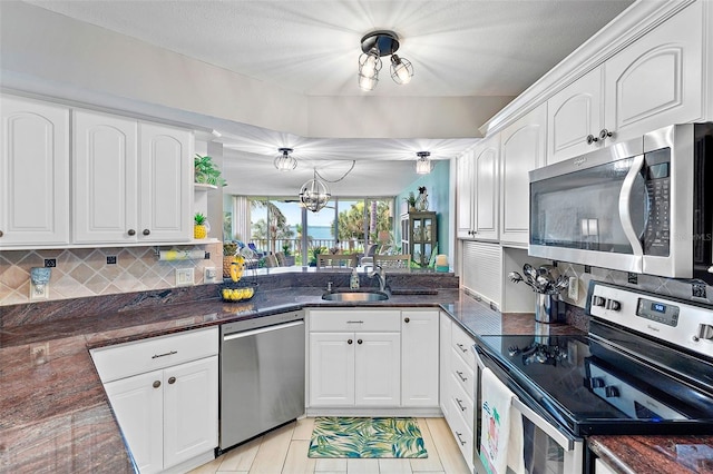 kitchen featuring stainless steel appliances and white cabinets