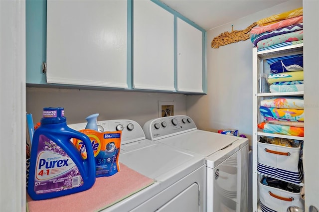 washroom with cabinets and washing machine and clothes dryer