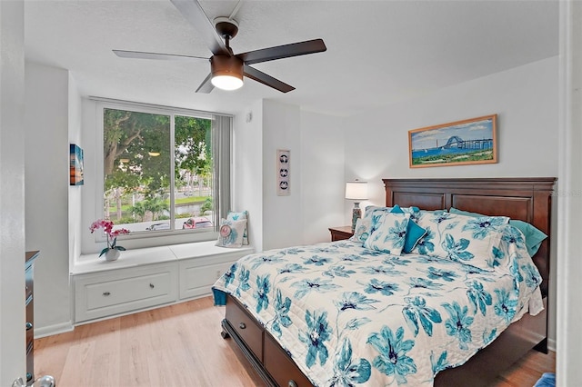 bedroom featuring ceiling fan and light hardwood / wood-style flooring