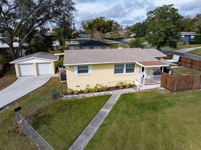 single story home featuring a porch, central AC, a front yard, a garage, and an outbuilding