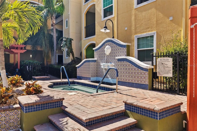 view of swimming pool featuring a community hot tub