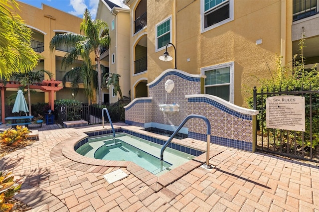 view of swimming pool featuring a community hot tub