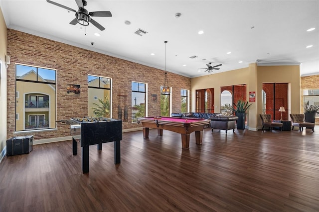 recreation room with brick wall, dark hardwood / wood-style floors, pool table, and ceiling fan