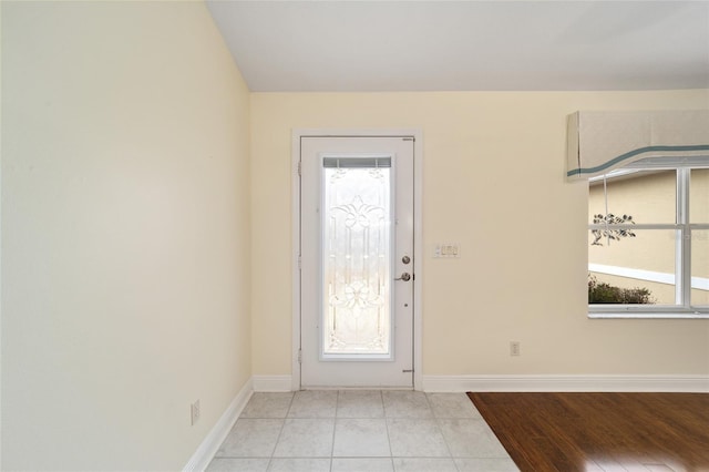 foyer entrance featuring light tile patterned floors and plenty of natural light