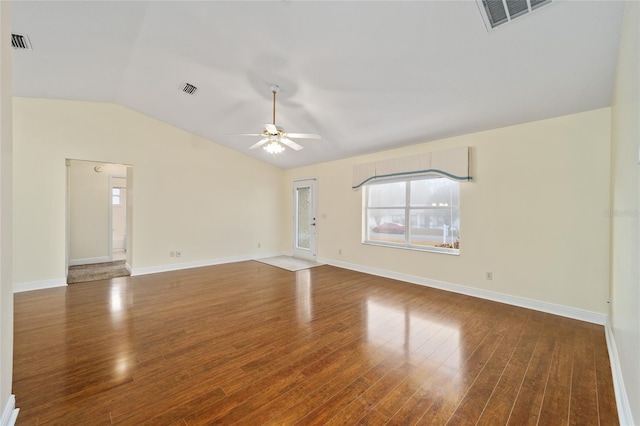 empty room featuring vaulted ceiling, dark hardwood / wood-style floors, and ceiling fan