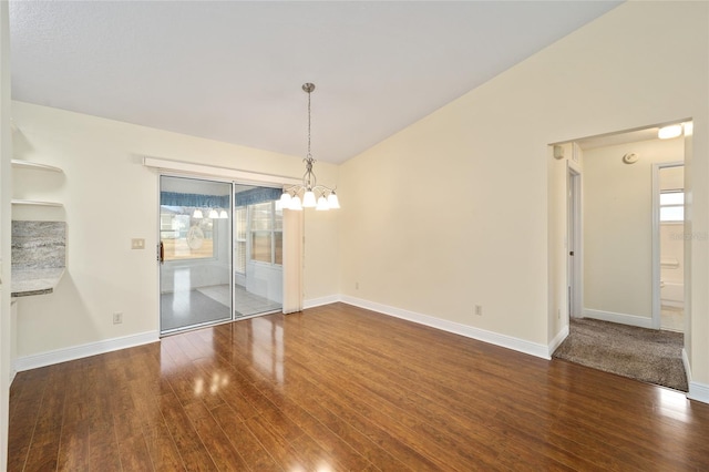 unfurnished dining area featuring an inviting chandelier, vaulted ceiling, and dark wood-type flooring