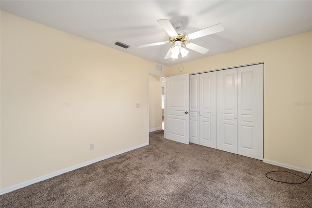 unfurnished bedroom with carpet flooring, ceiling fan, and a closet