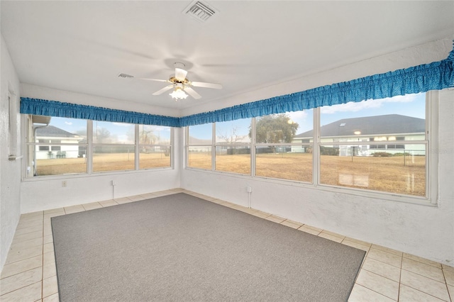 unfurnished sunroom featuring ceiling fan