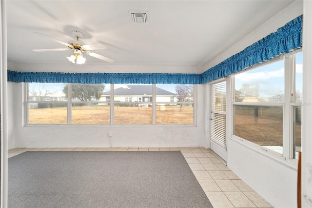 unfurnished sunroom featuring plenty of natural light and ceiling fan