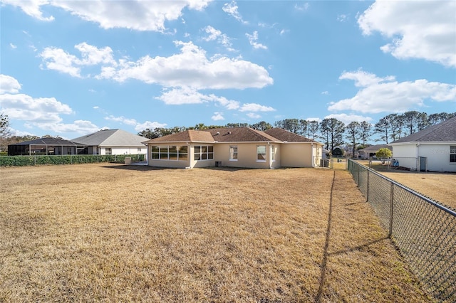 back of property featuring a yard and a sunroom