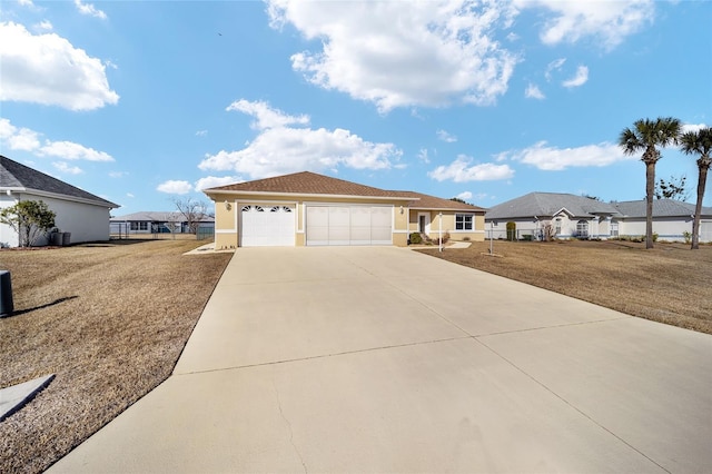 ranch-style house featuring a garage and a front lawn