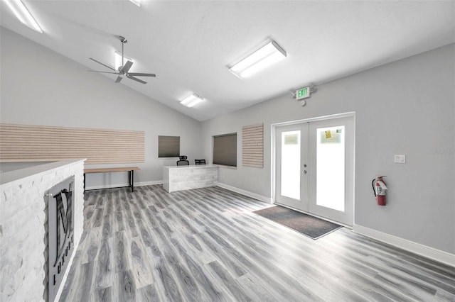 interior space featuring lofted ceiling, light wood-type flooring, and french doors