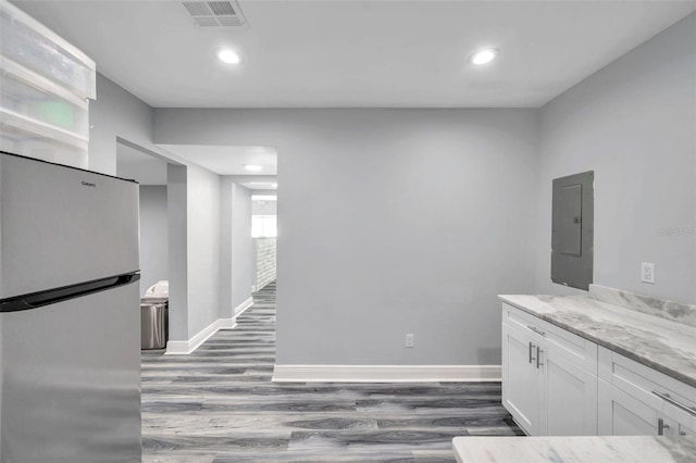 interior space featuring hardwood / wood-style floors and electric panel