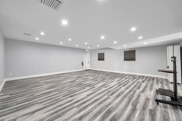 workout room with light hardwood / wood-style floors