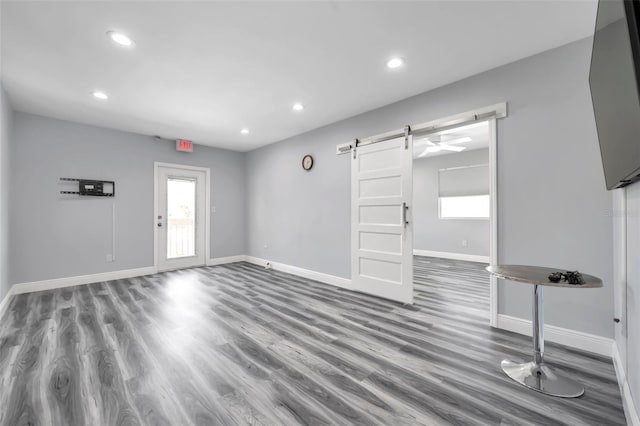 interior space featuring a barn door and hardwood / wood-style floors