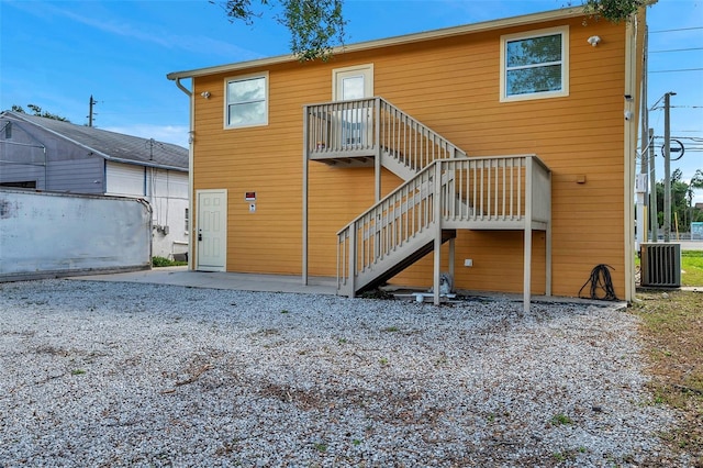 rear view of property featuring cooling unit