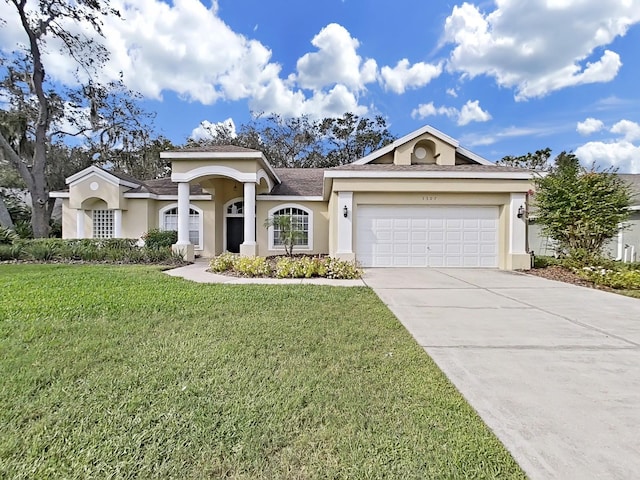 view of front of house with a garage and a front lawn