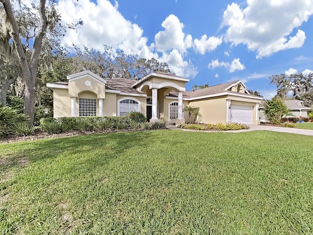 view of front of house featuring a garage and a front lawn