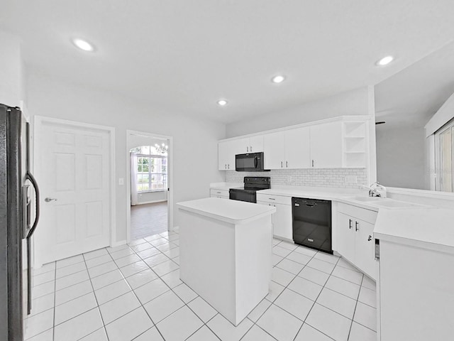 kitchen featuring light tile patterned floors, backsplash, black appliances, white cabinets, and kitchen peninsula