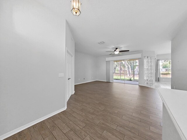 unfurnished living room with hardwood / wood-style flooring and ceiling fan