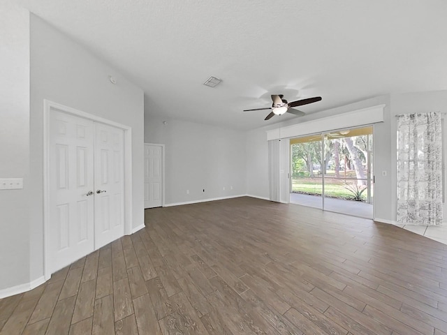 empty room with dark wood-type flooring and ceiling fan