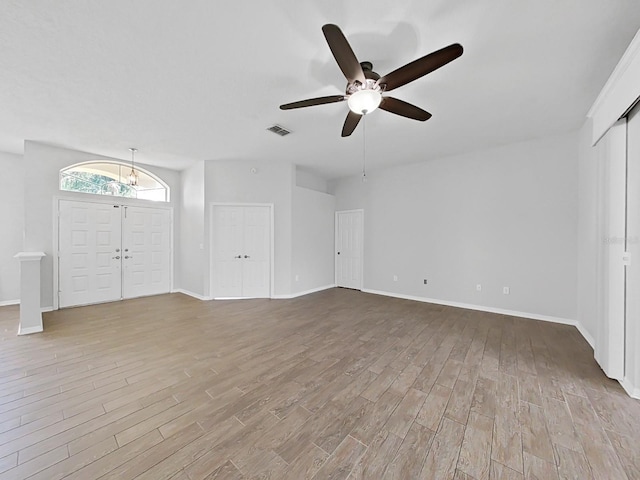 unfurnished living room with ceiling fan and light hardwood / wood-style floors