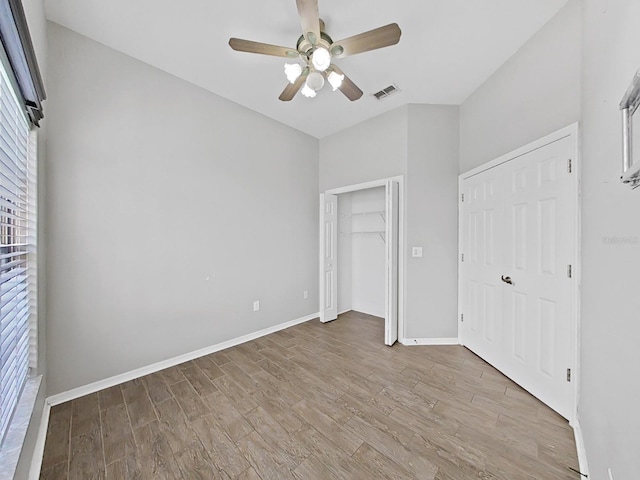 unfurnished bedroom with light hardwood / wood-style floors, a closet, and ceiling fan