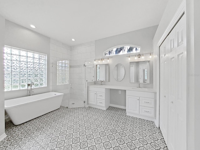 bathroom featuring vanity and separate shower and tub