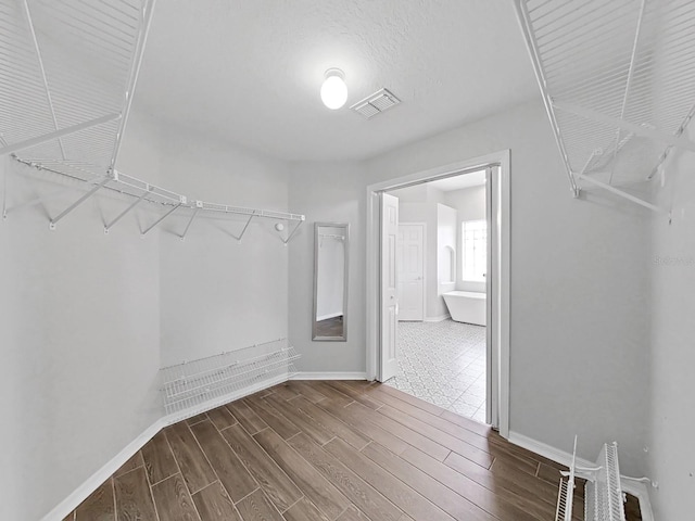 walk in closet featuring dark hardwood / wood-style floors