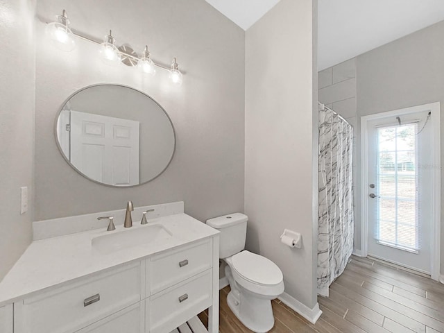 bathroom with vanity, hardwood / wood-style floors, walk in shower, and toilet