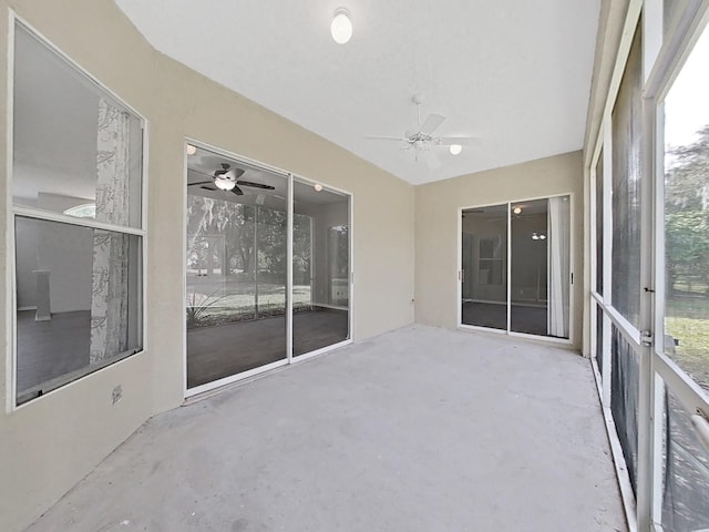 unfurnished sunroom featuring ceiling fan
