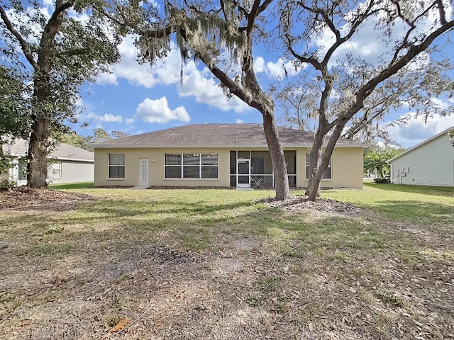 back of property with a yard
