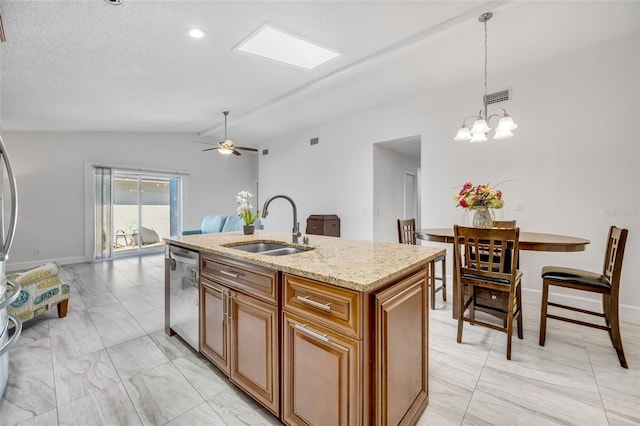 kitchen with sink, dishwasher, a kitchen island with sink, light stone countertops, and decorative light fixtures