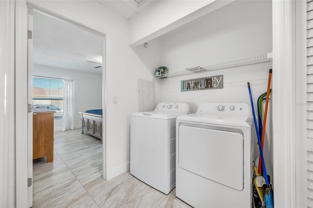 washroom featuring washing machine and dryer and a textured ceiling