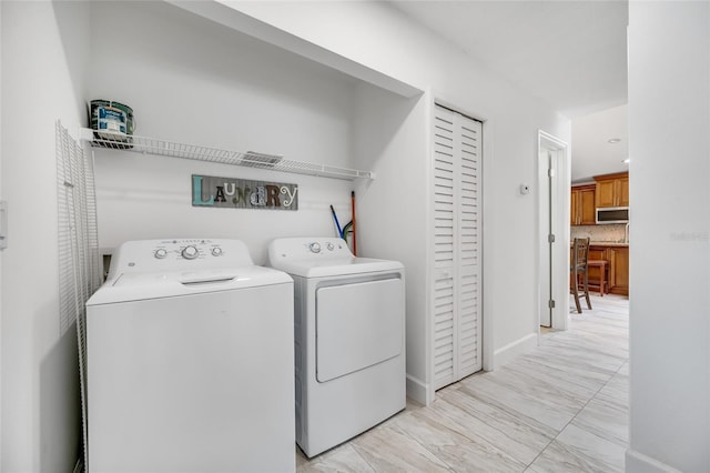 washroom featuring independent washer and dryer