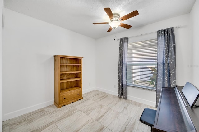 office area with ceiling fan and a textured ceiling