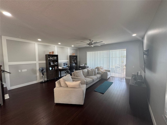 living room featuring dark hardwood / wood-style flooring and ceiling fan