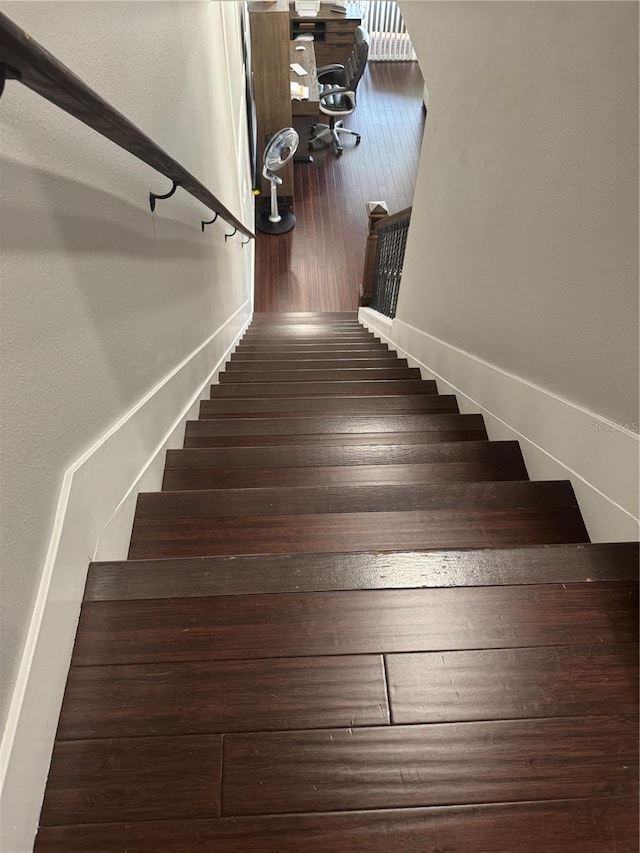 staircase with wood-type flooring